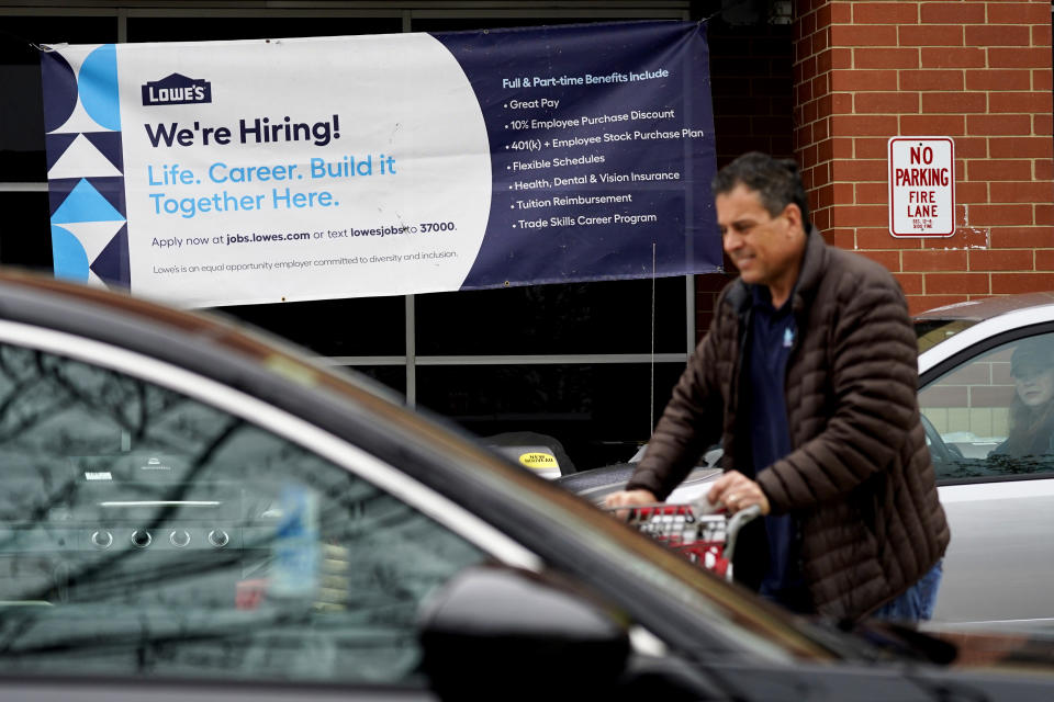 A hiring sign is displayed at a home improvement store in Northbrook, Ill., Thursday, May 5, 2022. America’s employers added 428,000 jobs in April, extending a streak of solid hiring that has defied punishing inflation, chronic supply shortages, the Russian war against Ukraine and much higher borrowing costs. (AP Photo/Nam Y. Huh)