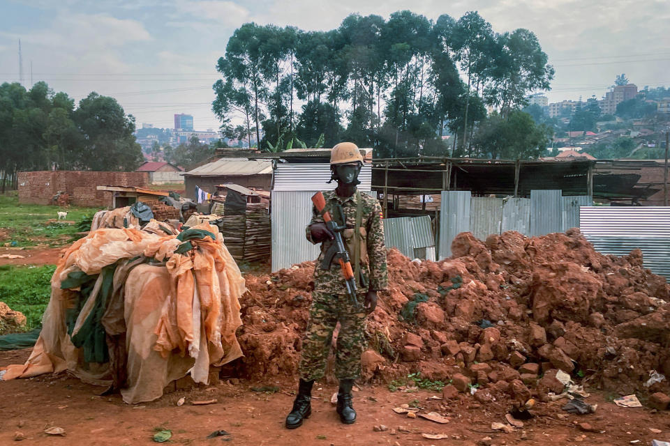 Ugandan security forces guards a checkpoint Kampala, Uganda, Saturday Jan. 16, 2021, after Ugandan President Yoweri Kaguta Museveni was declared winner of the presidential elections. (AP Photo/Jerome Delay)