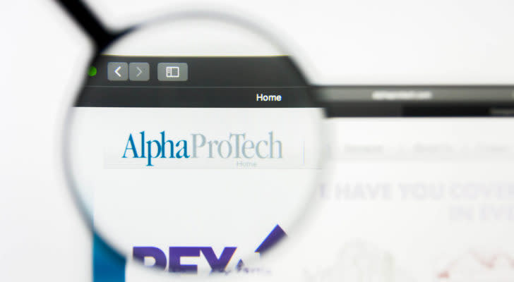 A magnifying glass zooms in on the Alpha Pro Tech (APT) website.