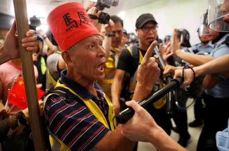 A protester shouts at the police officers at Amoy Plaza shopping mall in Kowloon Bay, Hong Kong