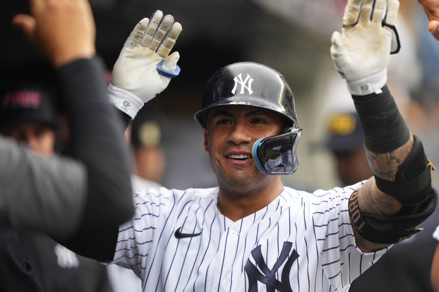 New York Yankees second baseman Gleyber Torres (25) is congratulated by teammates for hitting a home run against the Tampa Bay Rays during the second inning at Yankee Stadium.