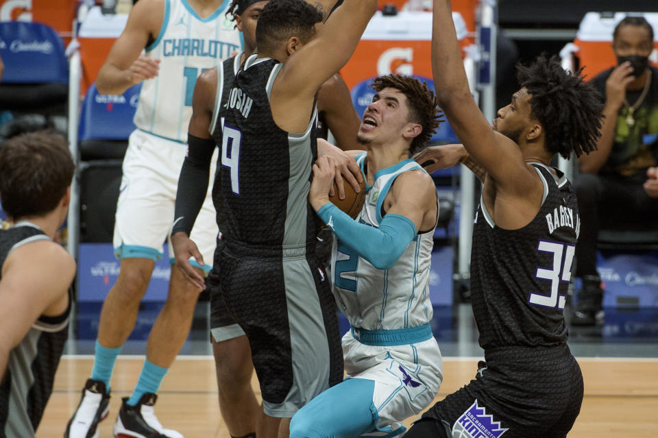 Sacramento Kings guard Cory Joseph (9) fouls Charlotte Hornets guard LaMelo Ball (2) during the first quarter of an NBA basketball game in Sacramento, Calif., Sunday, Feb. 28, 2021. (AP Photo/Randall Benton)