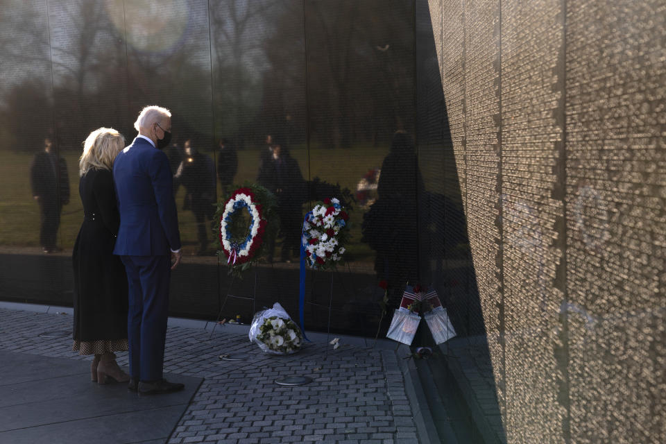 President Joe Biden and first lady Jill Biden pause after laying flowers as they visit the Vietnam Veterans Memorial to commemorate Vietnam War Veterans Day, Monday, March 29, 2021, in Washington. (AP Photo/Evan Vucci)