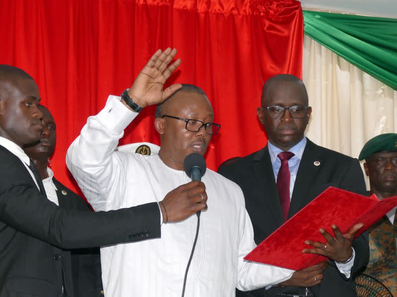 Guinea-Bissau's newly elected president Umaro Cissoko Embalo raises his arm during his swearing-in ceremony in Bissau