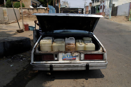 FILE PHOTO: Lino Lopez, husband of Maria Esis, who has kidney disease, uses his car to collect water during a blackout in Maracaibo, Venezuela April 11, 2019. REUTERS/Ueslei Marcelino