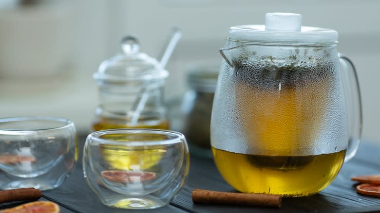 glass teapot brewing green tea