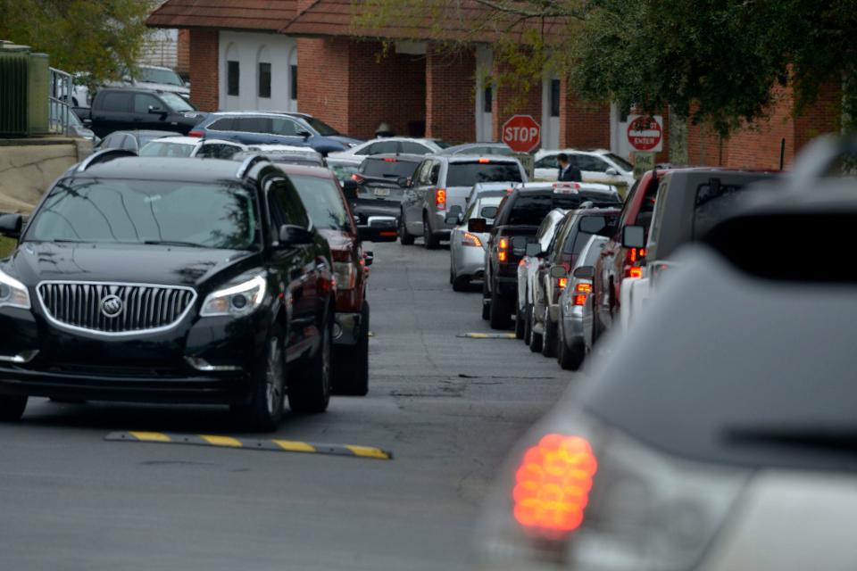 A long line of cars snakes around the Ascension Sacred Heart Hospital campus in Pensacola on Tuesday as people seek COVID-19 tests. The hospital has once again restarted its curbside COVID-19 testing program.