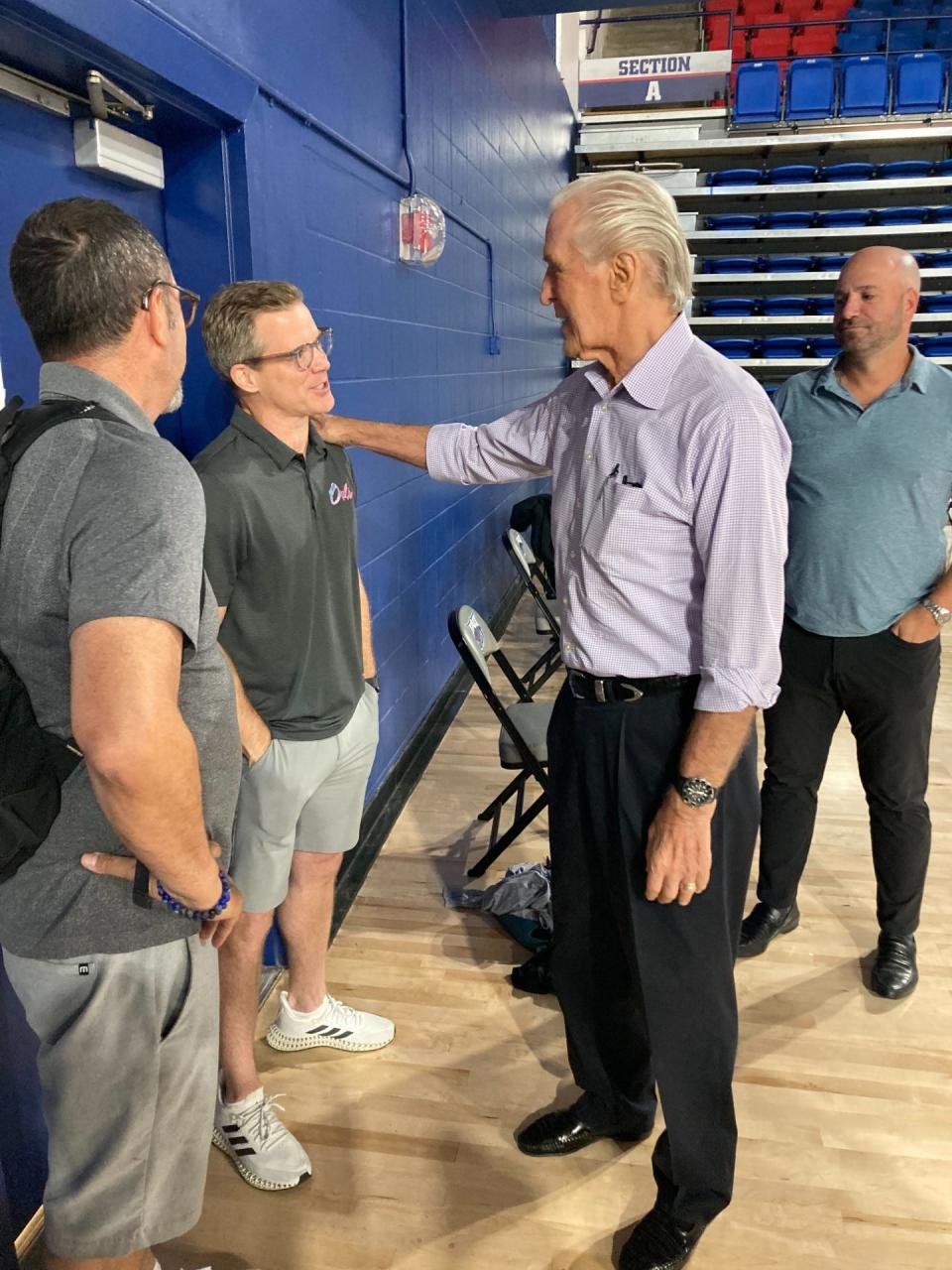 Heat President Pat Riley talks to FAU men's basketball coach Dusty May Tuesday in Boca Raton.