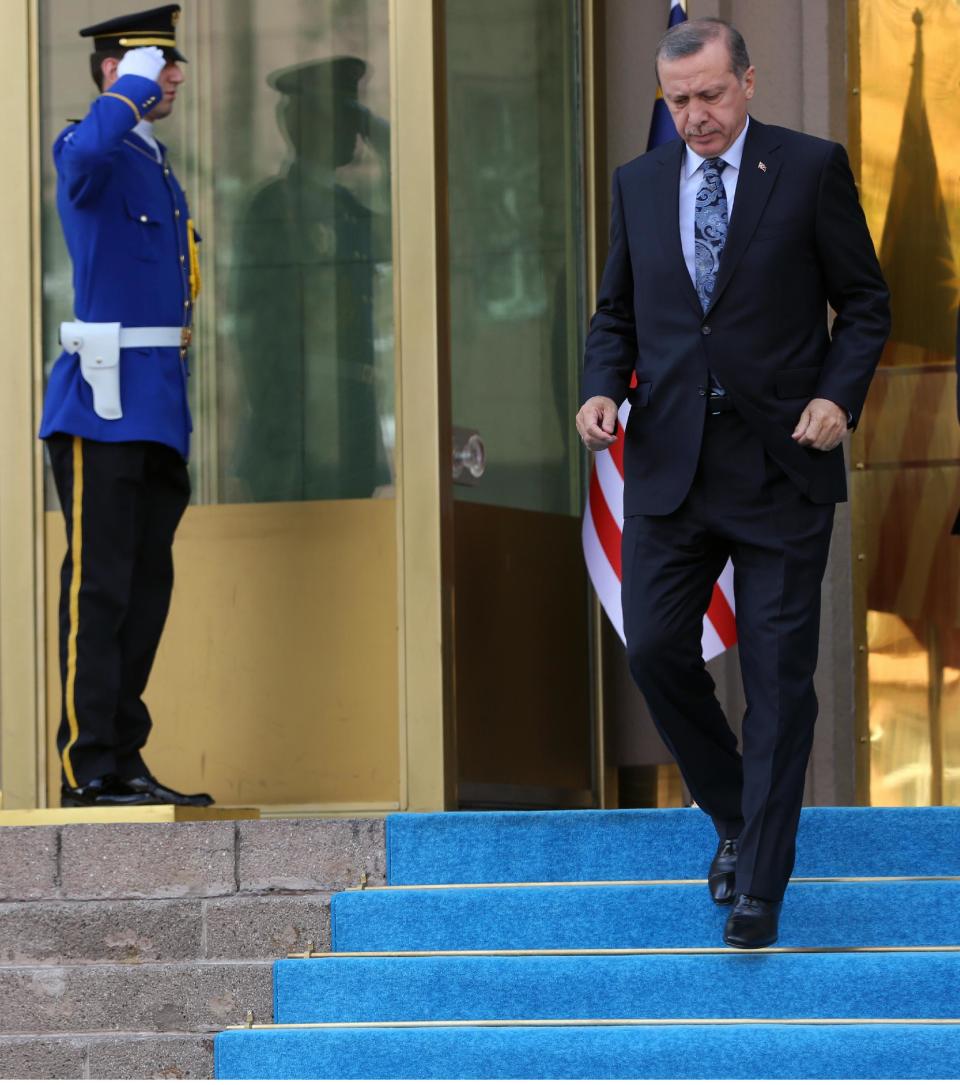 Turkish Prime Minister Recep Tayyip Erdogan walks outside his office in Ankara, Turkey, Thursday, April 17, 2014. Turkey's parliament looks set to pass a bill that increases the powers and immunities of the country's spy agency. It is the latest in a string of moves critics say is undermining democracy in the country that is a candidate to join the European Union. The bill, expected to be voted on Thursday, gives the National Intelligence Agency greater eavesdropping and operational powers and increases its immunities and abilities to keep tabs on citizens. Journalists publishing classified documents would face prison terms. (AP Photo/Burhan Ozbilici)