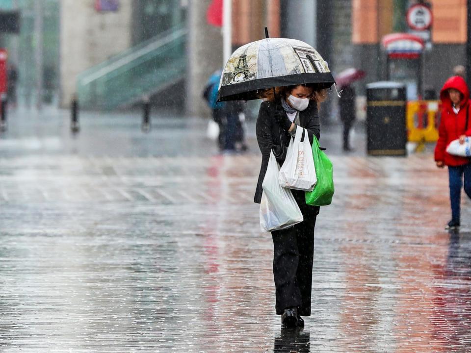 A shopper walks through the rain with an umbrella on 5 June, 2020: Peter Byrne/PA Wire