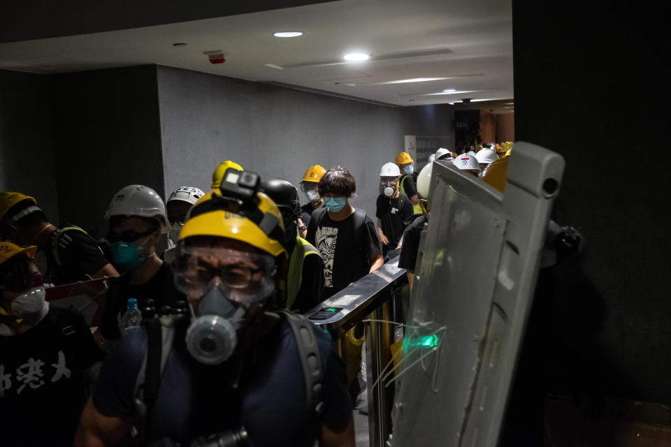 HONG KONG, HONG KONG - JULY 01: Protesters break into the Legislative Council Complex protest against the extradition bill on July 1, 2019 in Hong Kong, China. Hundreds of pro-democracy protesters broke into Hong Kong's legislature on Monday during the 22nd anniversary of the territory's return to China from Britain after riot police officers used batons and pepper spray to push back demonstrators. The city's embattled leader Carrie Lam watched a flag-raising ceremony on a video display from inside a convention center, citing bad weather, as tens of thousands protesters marched separately after the ceremony that morning. (Photo by Billy H.C. Kwok/Getty Images)