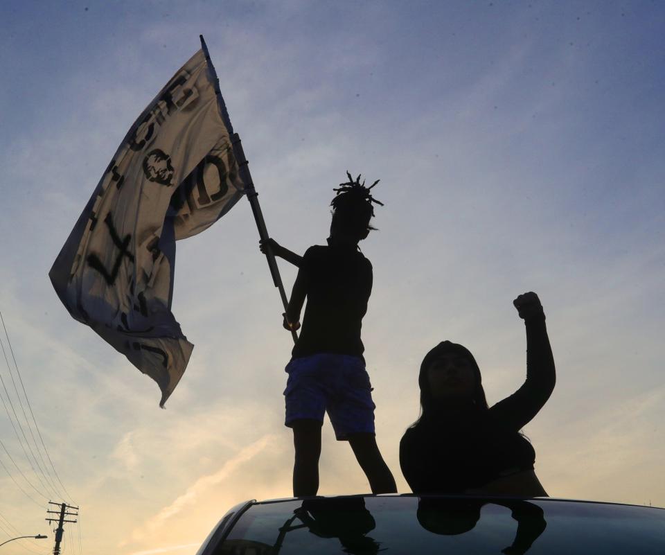 Jayland Walker protesters stand on their car parked in the middle of Copley Road Wednesday in Akron.