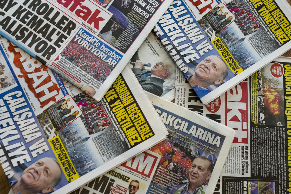 Newspapers display news of Turkish President and People's Alliance's presidential candidate Recep Tayyip Erdogan and CHP party leader and Nation Alliance's presidential candidate Kemal Kilicdaroglu, center, in a kiosk in Istanbul, Turkey, Friday, May 5, 2023. (AP Photo/Emrah Gurel)