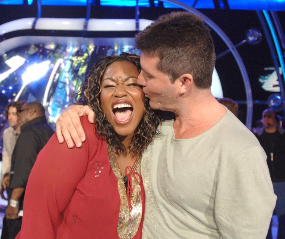 The Grammy-winning singer, getting a smooch from Simon Cowell, was on “American Idol” in 2006. WireImage