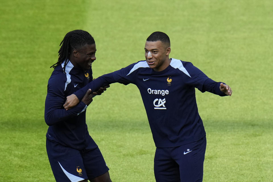 France's Kylian Mbappe, right, jokes with his teammate France's Eduardo Camavinga during a training session in Paderborn, Germany, Wednesday, June 19, 2024. France will play against Netherland during their Group D soccer match at the Euro 2024 soccer tournament on June 21. (AP Photo/Hassan Ammar)