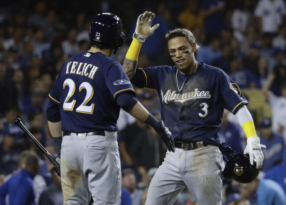 Milwaukee Brewers' Orlando Arcia reacts after scoring from first on a double by Domingo Santana during the fifth inning of Game 4 of the National League Championship Series baseball game against the Los Angeles Dodgers Tuesday, Oct. 16, 2018, in Los Angeles. (AP Photo/Matt Slocum)