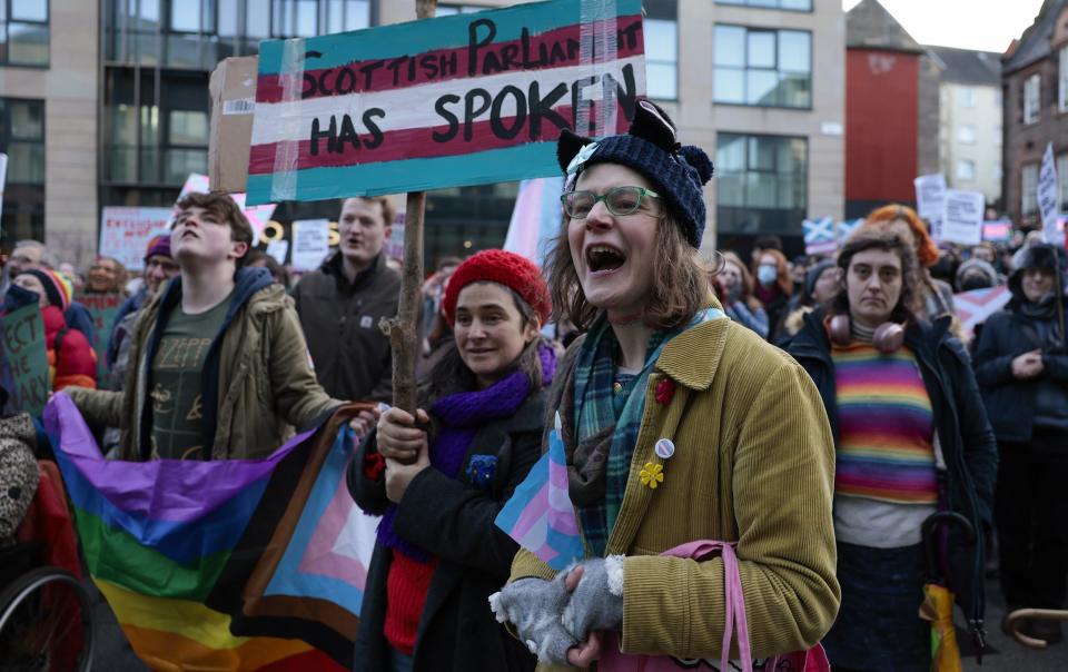 Trans right protesters outside Queen Elizabeth House in Glasgow earlier this month - Jeff J Mitchell/Getty Images