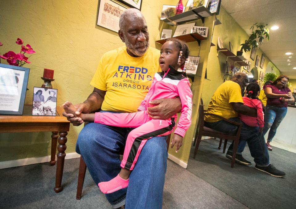 Sarasota County Commission candidate Fredd Atkins spends time with his grandaughter, Beatrix Atkins, 2, as he awaits results with family at JetsonÕs Unisex Salon in Sarasota on election night Nov. 8, 2022.  MATT HOUSTON/HERALD-TRIBUNE