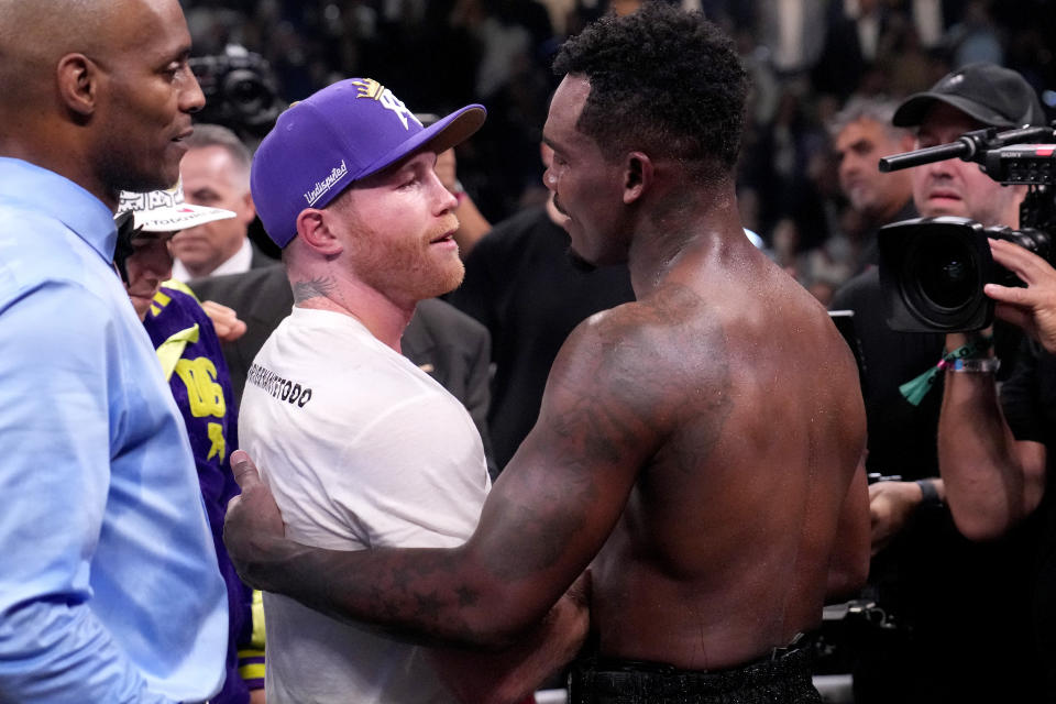 Canelo Alvarez, of Mexico, left, embraces Jermell Charlo after defeating Charlo in their super middleweight title boxing match, Saturday, Sept. 30, 2023, in Las Vegas. (AP Photo/John Locher)