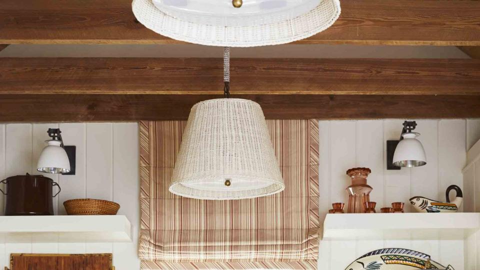 mahogany countertops, abaco pine beams, and vintage wicker pendant shades ground the kitchen in organic island simplicity