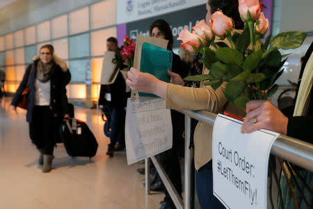 Opponents of U.S. President Donald Trump's executive order travel ban greet international travelers at Logan Airport in Boston, Massachusetts, U.S. February 3, 2017. REUTERS/Brian Snyder