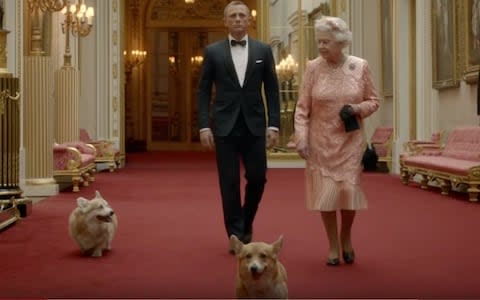 Daniel Craig and Queen Elizabeth II with her corgis - Credit: Videograb