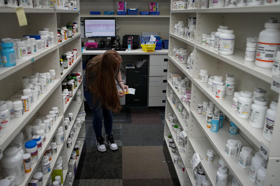 Christina McGowan fills orders at the Table Rock Pharmacy on Friday, Jan. 6, 2023, in Morganton, N.C. Drugstore chains are still trying to find enough employees to put a stop to temporary pharmacy closures. (AP Photo/Chris Carlson)