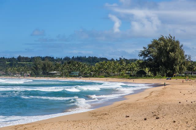 <p>Jon G. Fuller/getty</p> Waves and surf on Hanalei Beach on Hanalei Bay on the Island of Kauai, Hawaii