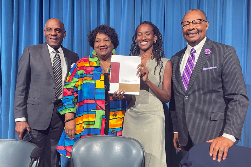 FILE - From left, state Sen. Steven Bradford, Secretary of State Shirley Weber, task force member Lisa Holder and Assemblymember Reggie Jones-Sawyer hold up a final report of the California Task Force to Study and Develop Reparation Proposals for African Americans during a hearing in Sacramento, Calif., Thursday, June 29, 2023. California's Legislative Black Caucus released a slate of reparations bills this week that strive to implement ideas from a landmark task force that studied the issue for two years. The proposals include a formal apology from the state, for its role in facilitating slavery and compensation for property seized from Black owners. (AP Photo/Haven Daley, File)