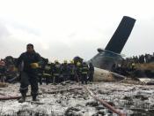 <p>Nepalese rescuers stand near a passenger plane from Bangladesh that crashed at the airport in Kathmandu, Nepal, March 12, 2018. (Photo: Niranjan Shreshta/AP) </p>