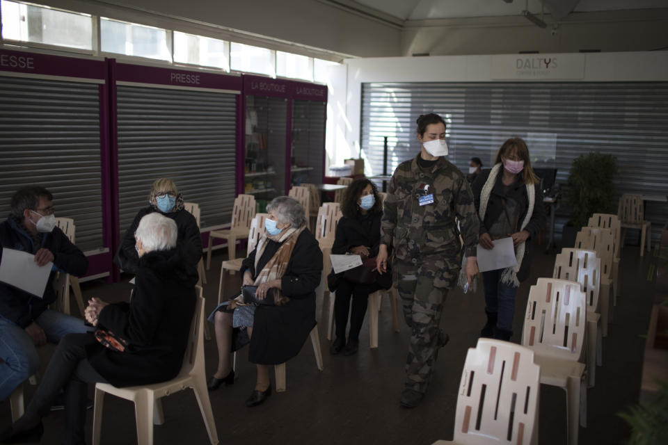 FILE - In this April 7, 2021, file photo, people wait to receive the Pfizer COVID-19 vaccine at the Laveran Military Hospital in Marseille, southern France. The European Union has ramped up its coronavirus vaccination efforts, even as infections remain doggedly high. (AP Photo/Daniel Cole, File)