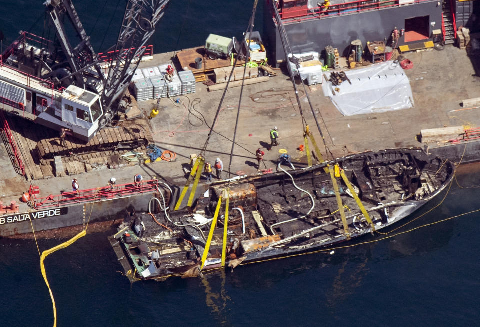 The burned hull of the Conception is brought to the surface by a salvage team, Thursday, Sept. 12, 2019, off Santa Cruz Island, Calif., in the Santa Barbara Channel in Southern California The vessel burned and sank on Sept. 2, taking the lives of 34 people aboard. Five survived. (Brian van der Brug/Los Angeles Times via AP)