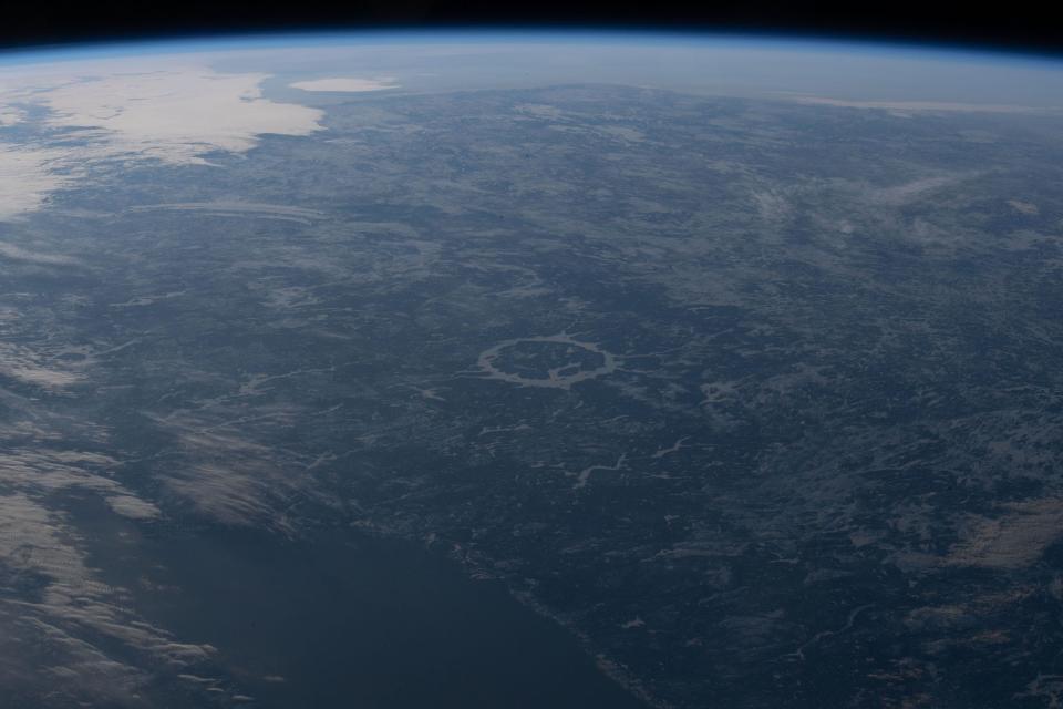 earth below with circle in the middle of green landscape