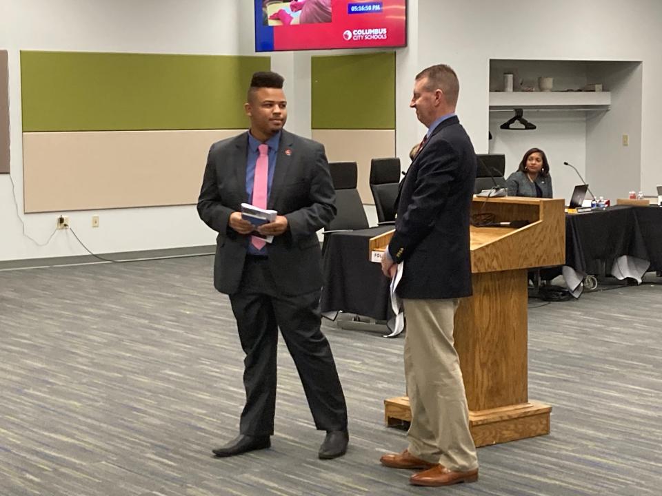 Brandon Simmons (left) is sworn in as a new member of the Columbus City School District Board of Education by state Rep. Adam Miller, D-Columbus, at the Jan. 9, 2024, board meeting. Simmons was elected in the Nov. 7, 2023, general election.