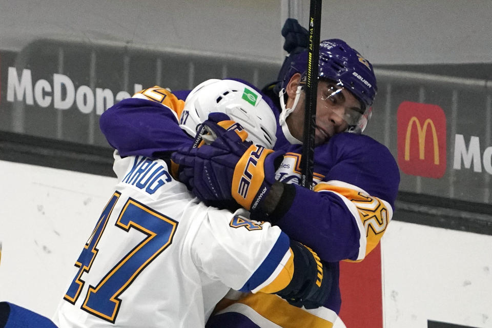 St. Louis Blues defenseman Torey Krug, left, and Los Angeles Kings left wing Andreas Athanasiou fight during the second period of an NHL hockey game Wednesday, March 17, 2021, in Los Angeles. (AP Photo/Mark J. Terrill)