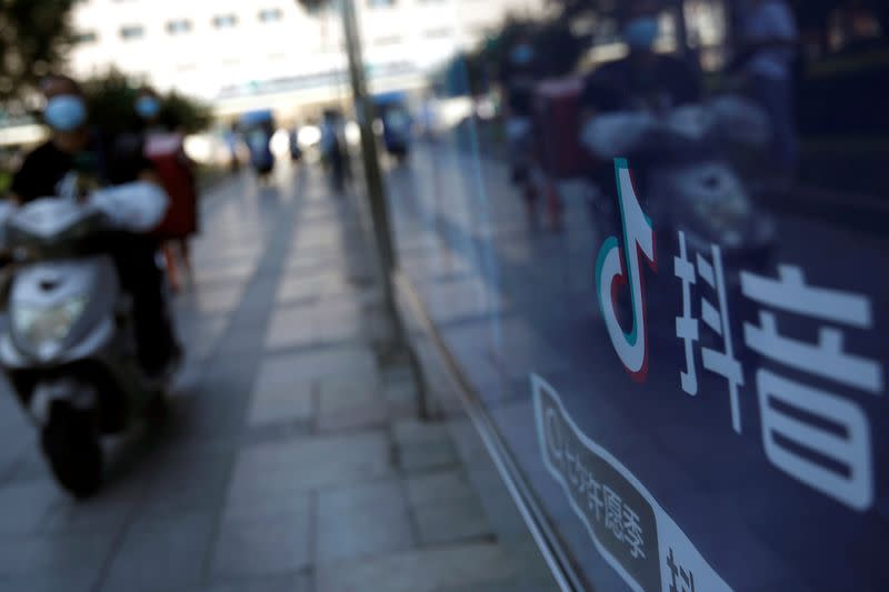 FILE PHOTO: A logo of TikTok (Douyin) is seen on an advertisement at a bus stop in Beijing