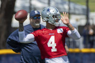 Dallas Cowboys quarterback Dak Prescott throws a pass as coach Mike McCarthy watches during the NFL football team's training camp in Oxnard, Calif., Thursday, July 22, 2021. (AP Photo/Michael Owen Baker)