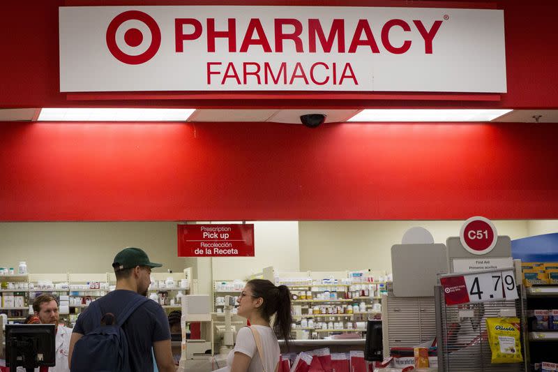 FILE PHOTO: Customers wait in line in the pharmacy department at a Target store in the Brooklyn borough of New York