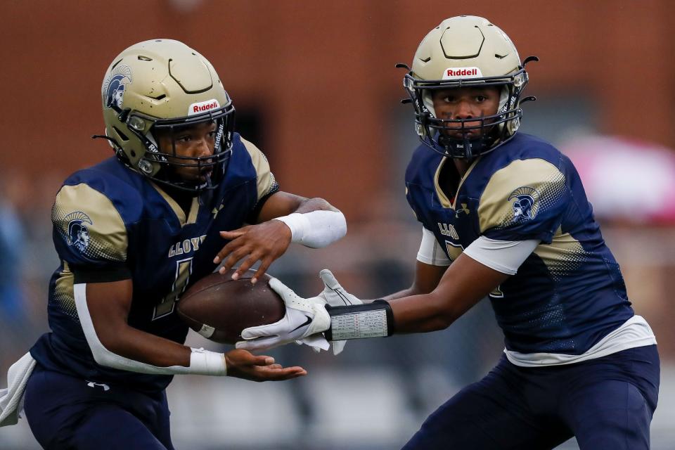 Lloyd Memorial quarterback Isaiah Sebastian (7) hands the ball off to running back Yurii Collins Comer (1). They hope to knock off Lexington Catholic this week.