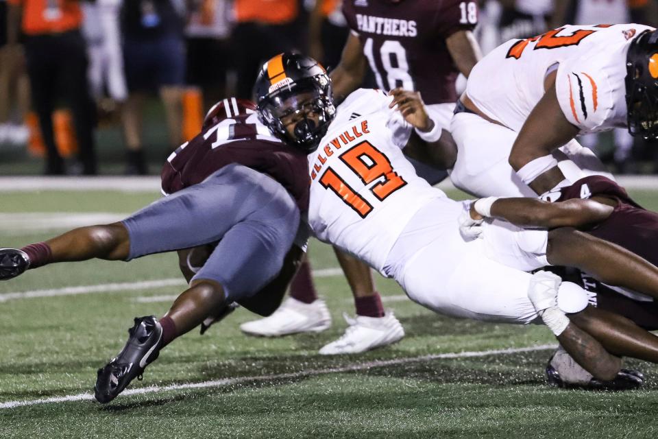 Belleville quarterback Bryce Underwood (19) is tackled by River Rouge linebacker Nicholas Marsh (11) during the second half of Prep Kickoff Classic at Wayne State University's Tom Adams Field in Detroi on Friday, August 25, 2023.