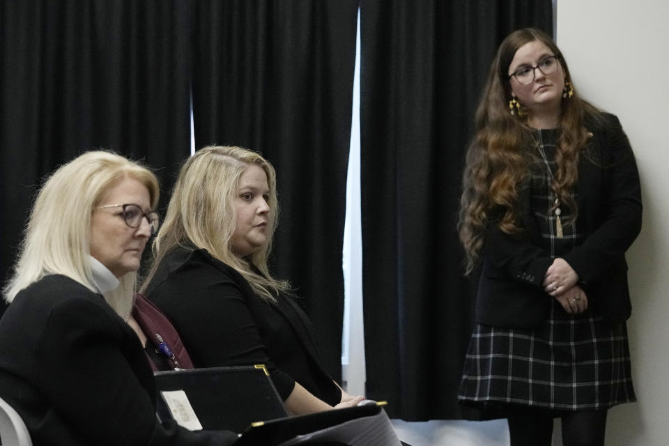 Jennifer Miller, left, Caroline Hunt, center, and Tessa Henry, right, all with the Attorney General's office, listen as convicted inmate Scott Eizember gives video testimony from the state penitentiary in McAlster, Okla., at his clemency hearing Wednesday, Dec. 7, 2022, in Oklahoma City. (AP Photo/Sue Ogrocki)