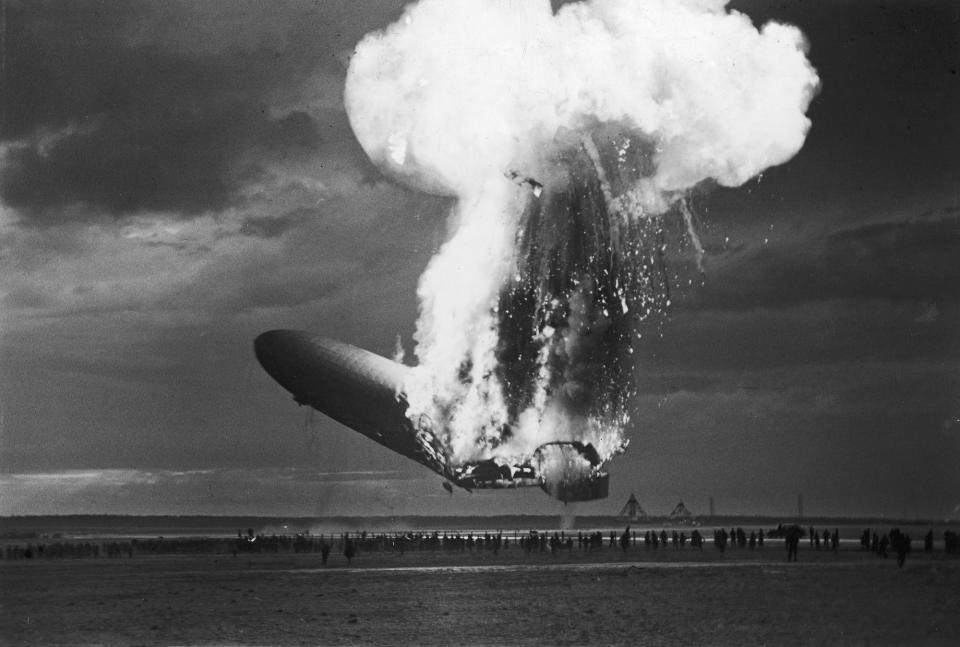 <p>The German-designed and built passenger airship the Hindenburg (LZ-129) catches fire as it attempts to land in Lakehurst, New Jersey, following it’s first cross-ocean flight of the year, May 6, 1937. The lighter-than-air craft had made more than 30 successful cross-ocean trips previously, but the disaster, in which 35 of the 90-odd passengers and crew members died, effectively ended this type of commerical air travel. (Arthur Cofod/Pictures Inc./The LIFE Picture Collection/Getty Images) </p>