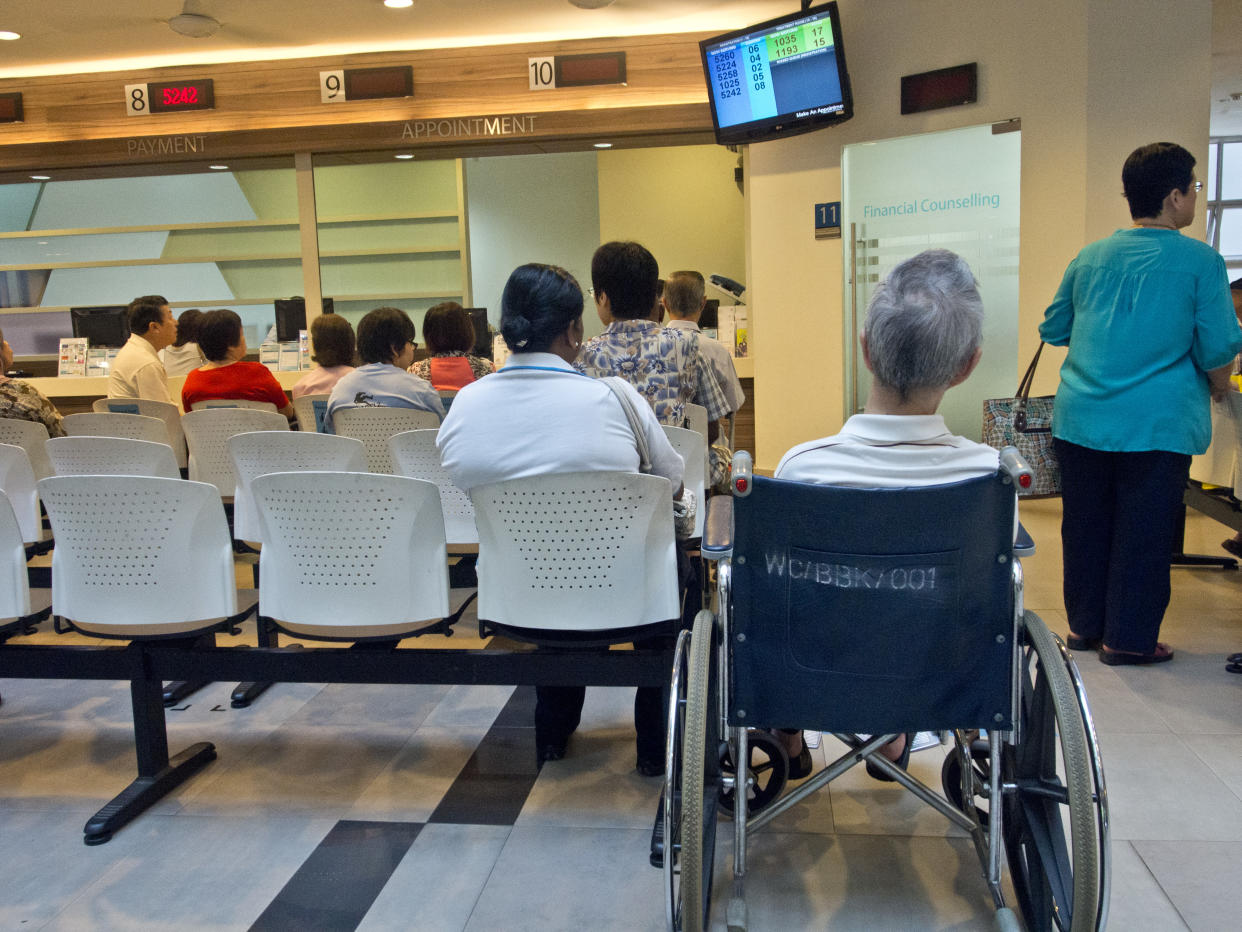 Patients waiting to be attended by doctors at a polyclinic medical centre in Singapore. (Photo by: Majority World/Universal Images Group via Getty Images)