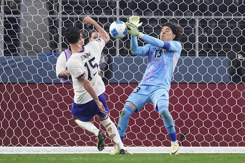 Mexico Goalkeeper Guillermo Ochoa, right, stops a shot from Unites States midfielder Johnny Cardoso during the second half of a CONCACAF Nations League final soccer match, Sunday, March 24, 2024, in Arlington, Texas. (AP Photo/Tony Gutierrez )