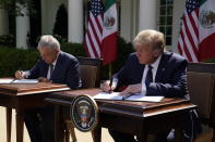 President Donald Trump and Mexican President Andres Manuel Lopez Obrador sign a joint declaration at the White House, Wednesday, July 8, 2020, in Washington. (AP Photo/Evan Vucci)