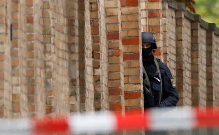 A police officer stands guard at the site of a shooting in Halle