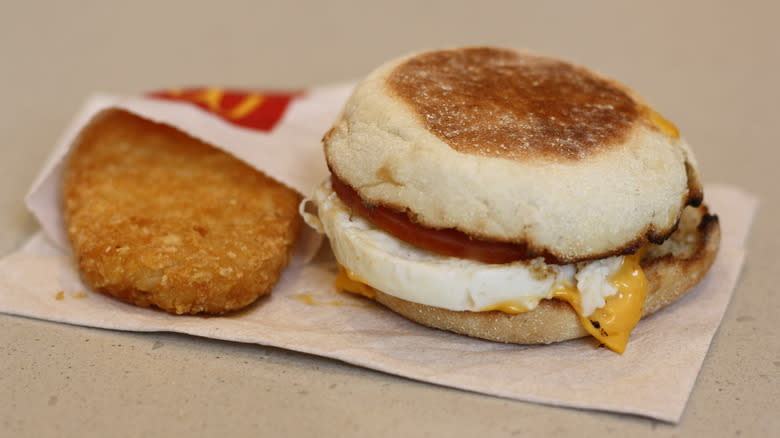 Egg McMuffin and hashbrown on paper napkin