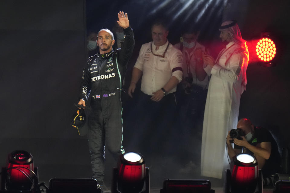 Mercedes driver Lewis Hamilton of Britain waves from the podium after winning the Formula One Saudi Arabian Grand Prix in Jiddah, Sunday, Dec. 5, 2021. (AP Photo/Hassan Ammar)