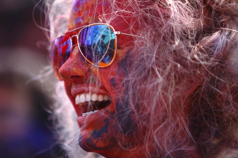 A tourist celebrates Holi, the Festival of Colours, in Kathmandu March 16, 2014. Holi marks the beginning of spring and is celebrated with great enthusiasm all over Nepal. REUTERS/Navesh Chitrakar (NEPAL - Tags: RELIGION SOCIETY TRAVEL)