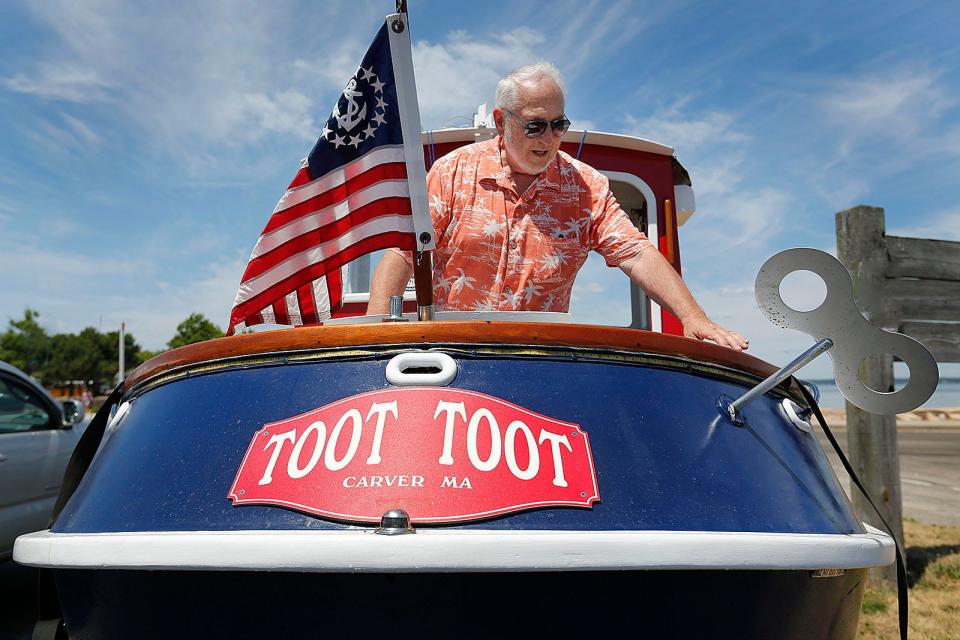 Mike Magnant, of Middleboro, with a tugboat he built and named Toot Toot in Plymouth Harbor Wednesday, July 27, 2022.